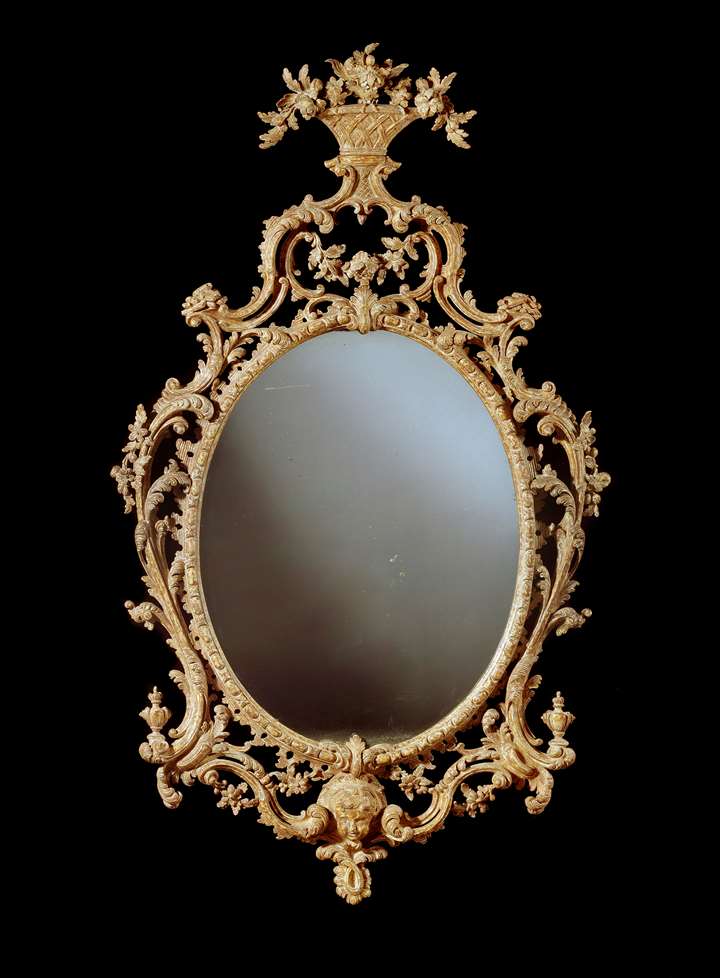 A George III giltwood oval mirror